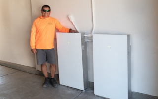 Tesla Powerwall 3 and our Synergy Power installer in a garage